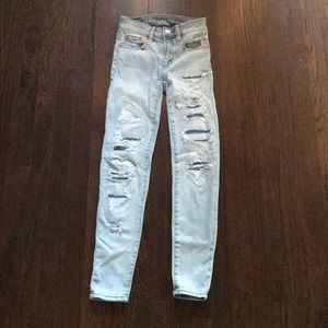 light wash denim with dark denim patches holes